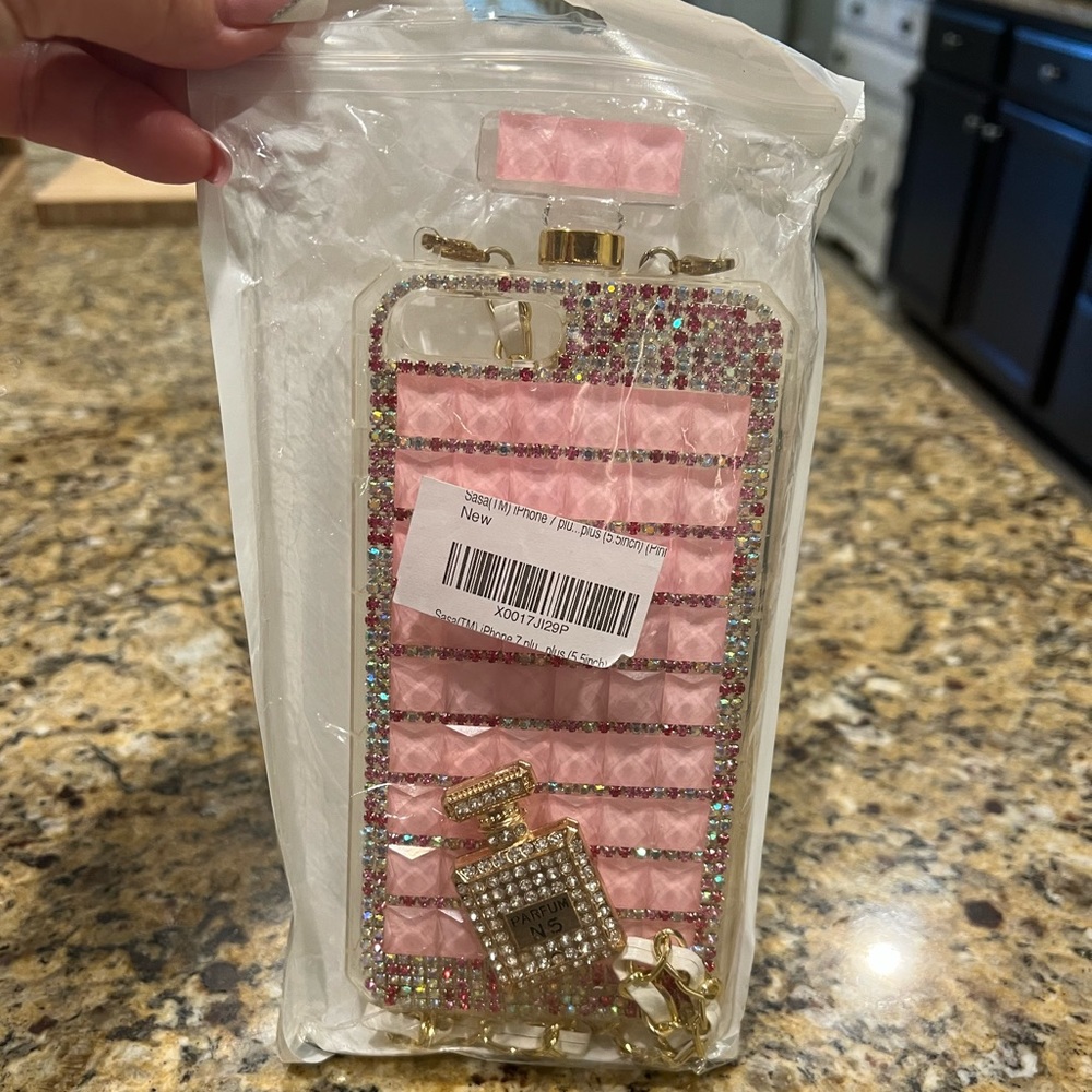Pink perfume bottle phone case with clear and pink rhinestones.